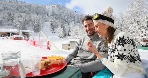 Couple of skiers having a snack on skiing day